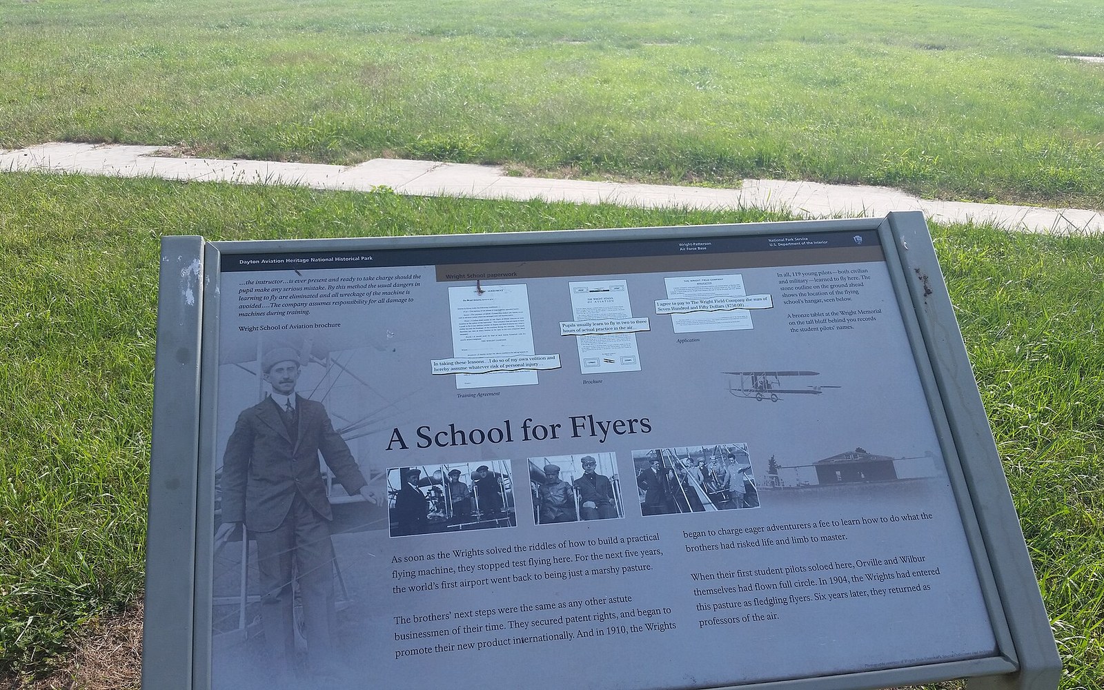 Outdoor historical marker titled "A School for Flyers" describing the Wright brothers' flight training