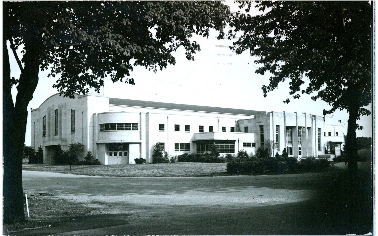 Black and white archival photo of Hobart Arena's art deco exterior framed by trees